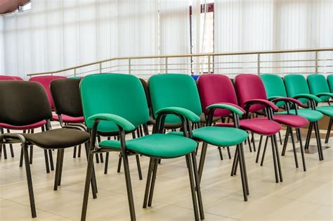 Premium Photo | Office chairs of different colors in the hall.