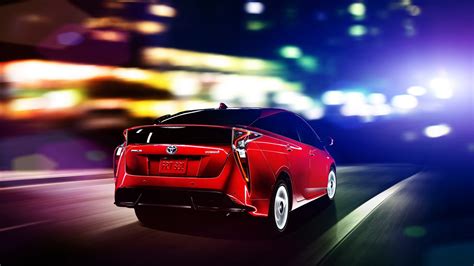 2016 Toyota Prius red rear three quarters North American specification official image