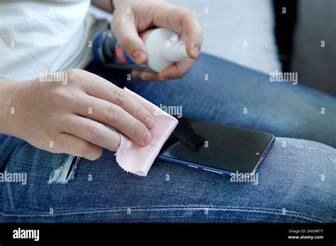 man cleaning smartphone screen with alcohol. Concept of Cleaning dirty screen phone for disease ...