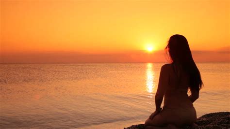 Silhouette Of A Woman Sitting On A Beach At Sunset Stock Footage Video 1338586 - Shutterstock