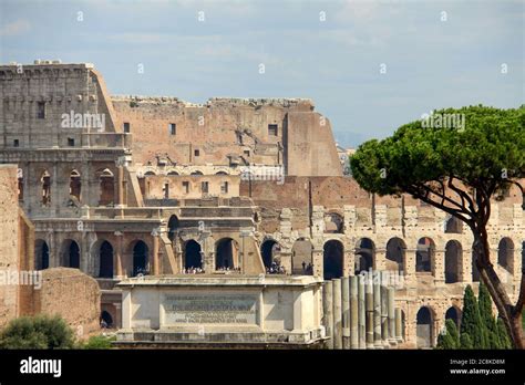 Rome, Italy. July, 2017. Detail of the Colliseum with visitors inside and the top of the Arch of ...