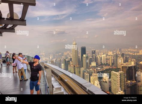 Visitors on top of the Menara KL Tower with view of the Kuala Lumpur ...
