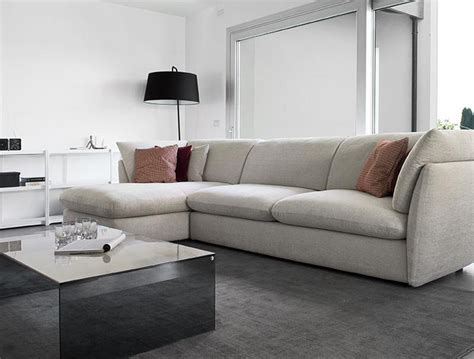 a living room with a couch, coffee table and large window in the center ...