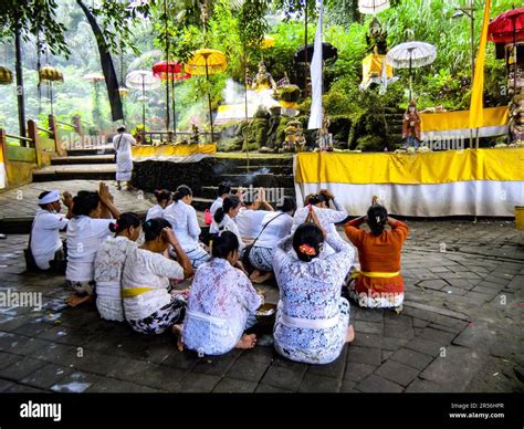 Bali Hinduism, devout people praying in front of shrine in Taman Beji Griya Waterfall, Kabupaten ...