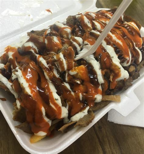 Halal snack pack (Doner kebab with BBQ sauce and garlic sauce over hot ...