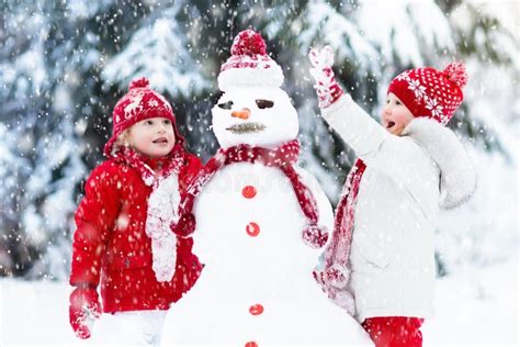 Kids Building Snowman. Children in Snow. Winter Fun. Stock Photo ...