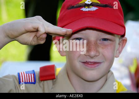 Boy scout in uniform performs three finger salute Stock Photo - Alamy