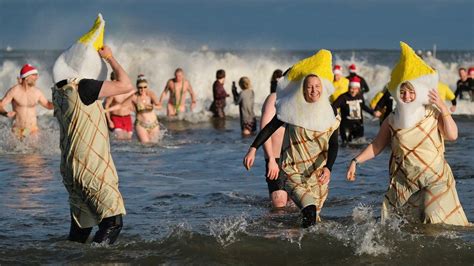 Boxing Day dippers brave chilly coastal waters for charity - BBC News