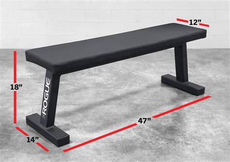 a black bench with measurements for the top and bottom portion, on concrete flooring