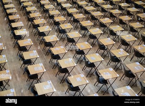 Examination hall set up with plastic chairs and wooden desks Stock ...