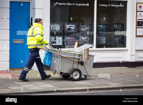 Street cleaner walking on a pavement in London, UK Stock Photo - Alamy