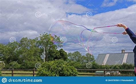 Giant Soap Bubble with Bubble Wand Stock Photo - Image of enjoyment, frei: 264378350