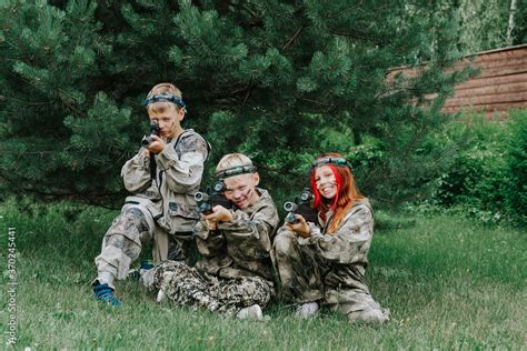 Children playing in lasertag shooting game, boy with a gun, war ...