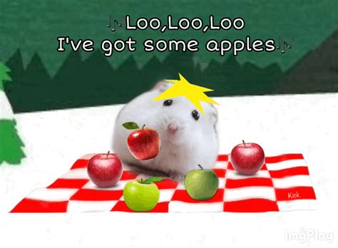 a white hamster eating apples on top of a checkered table cloth