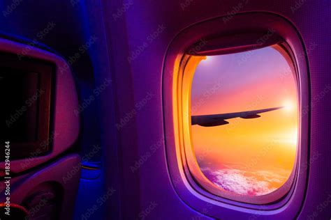 Beautiful scenic view of sunset through the aircraft window. Image save-path for window of ...