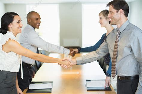 Business people shaking hands in meeting - Stock Image - F014/3065 ...