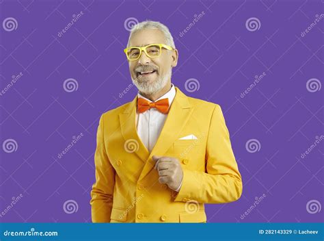 Cheerful Stylish Senior Man in Bright Yellow Suit Isolated on Purple Background. Stock Image ...