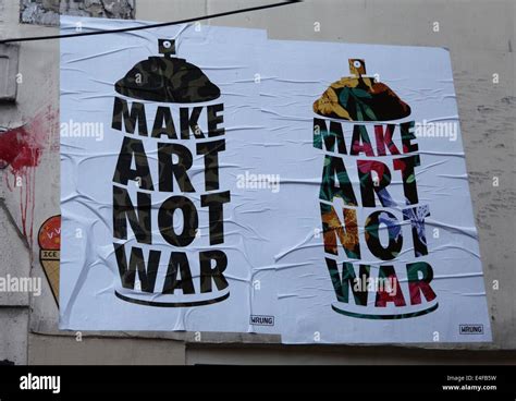 It's a photo of two street art posters in Paris city in France: Make Art not War Stock Photo - Alamy