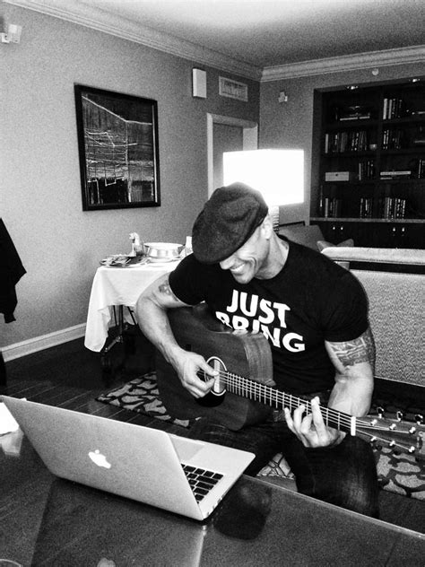 Image: The Rock tunes his guitar for the #RockConcert - # RAW20 ...