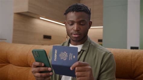 Black Man Holding Passport Typing On Stock Footage SBV-348540560 - Storyblocks