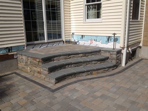 Natural stone steps with a blue stone cap leading to paver patio by ...