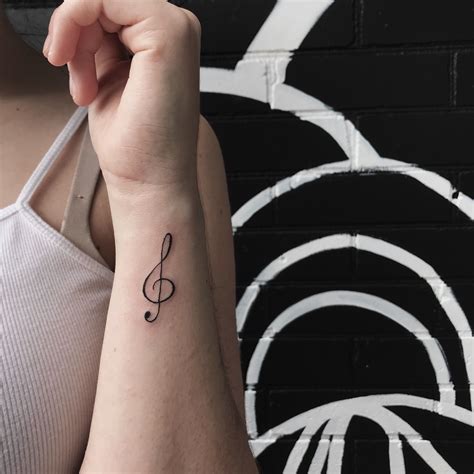 Treble clef tattoo | Wrist tattoos, Treble clef tattoo, Music tattoo designs