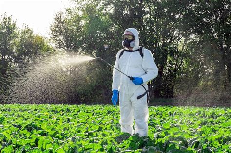 Premium Photo | Farmer spraying pesticide field mask harvest protective chemical