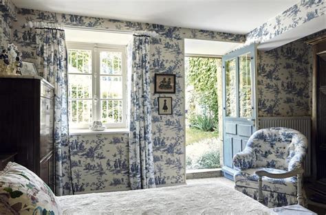 A toile de Jouy wallpaper and matching fabric from GP & J Baker Imogen’s bedroom opens onto the ...