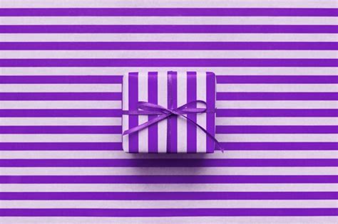 Premium Photo | Violet gift box on purple striped wrapping paper