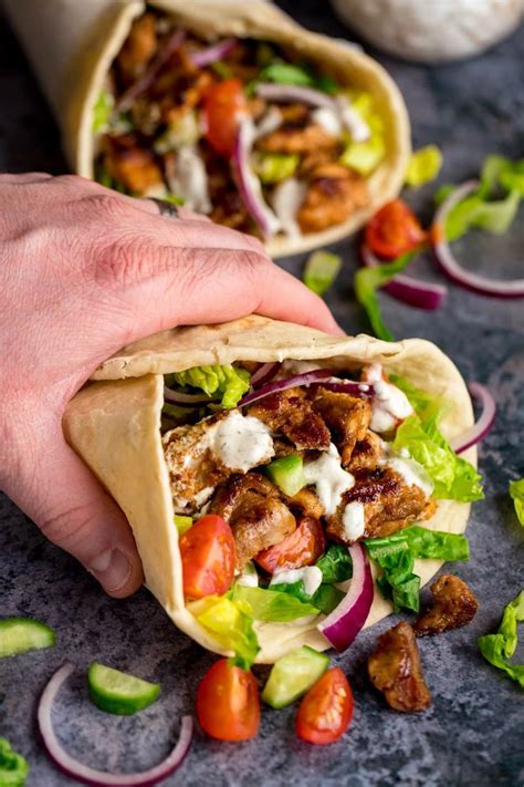 This Chicken Shawarma is juicy spiced chicken wrapped in flatbreads with a creamy, tahini ...