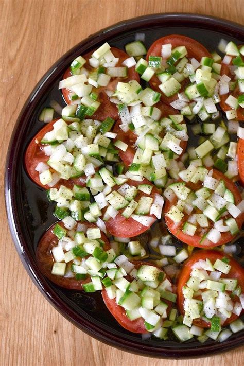 Sliced Tomato Salad with Cucumber Onion Marinade- Sliced tomatoes topped with a chopped ...