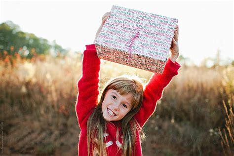 "Little Girl With Christmas Gift" by Stocksy Contributor "Erin Drago ...