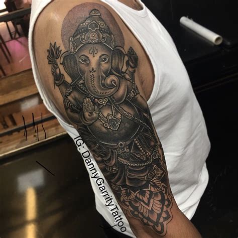 Ganesh tattoo design for upper sleeve in realistic black and grey