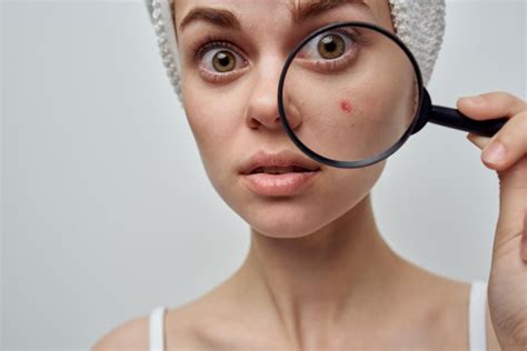 Premium Photo | Woman with a magnifying glass in hand cosmetology studio