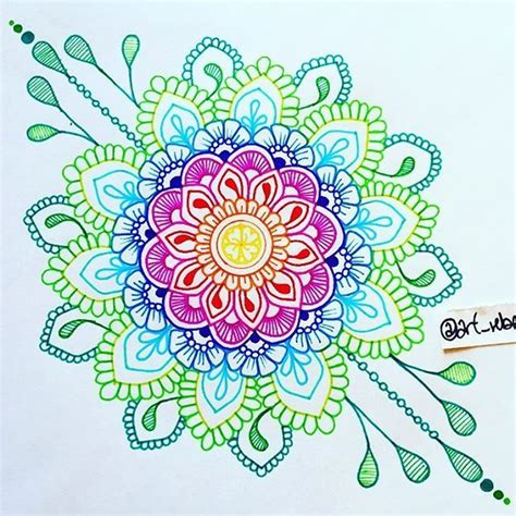 a drawing of a colorful flower on white paper