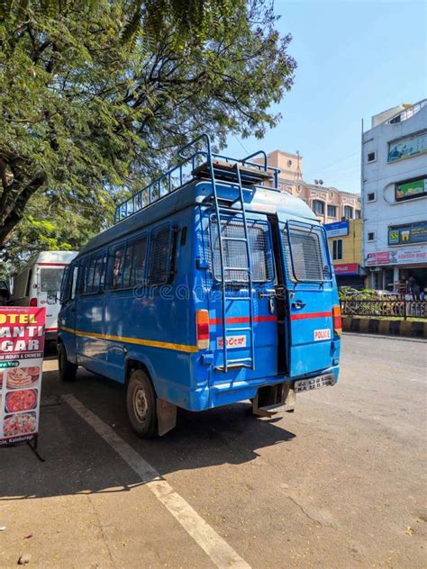 Back View of a Blue Police Van Can Be Seen Parked on the Roadside with ...