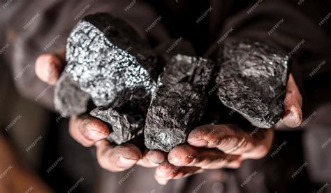 Premium Photo | Coal mining coal miner in the man hands of coal ...