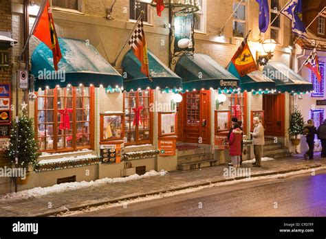 Brightly lit facade of the Restaurant du Parmesan in Old Quebec City ...