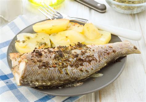 Baked Sea Bass with Potatoes on Dish Stock Photo - Image of potatoes, perspective: 75946882