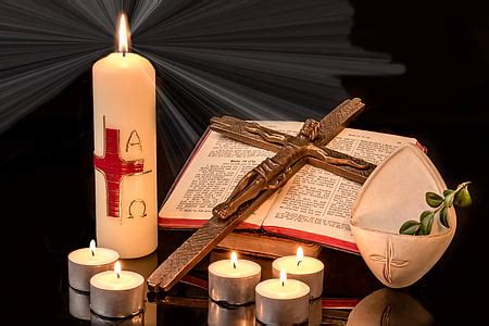 Royalty-Free photo: Lighted candle near crucifix photo | PickPik