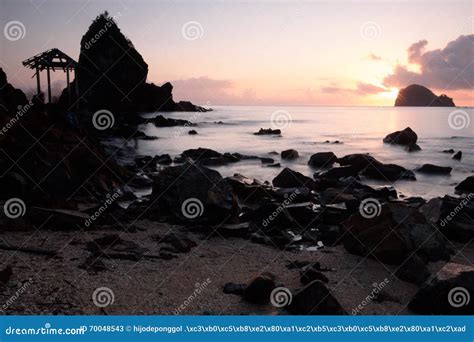 Watching Sunrise and Rock Formation at the Shore Stock Image - Image of rock, aurora: 70048543