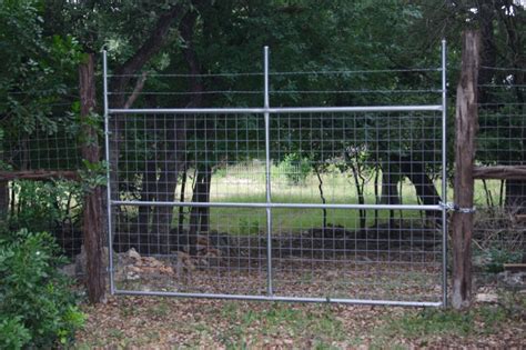 Welded wire gate with metal post frame and barbed wire - Superior Fence ...