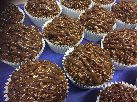 chocolate cupcakes with nuts on top and drizzled in the middle