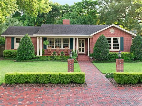 Extending the walkway into a brick parking pad created space for cars without compromising the ...