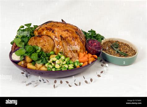 A Christmas roast turkey dinner with roast potatoes, chestnut stuffing ...