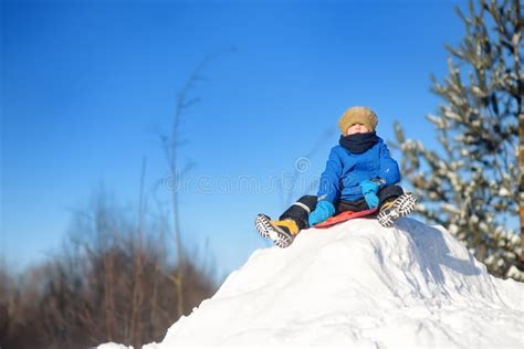 Little Boy Enjoy Riding on Ice Slide on Snowy Day. Baby Having Fun ...