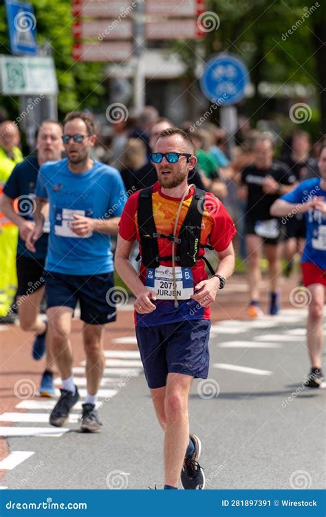 Group of People Running on a City Street in a Marathon Editorial Photo ...