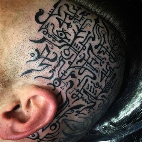 Beautiful sigil tattoos on the left side of the head.