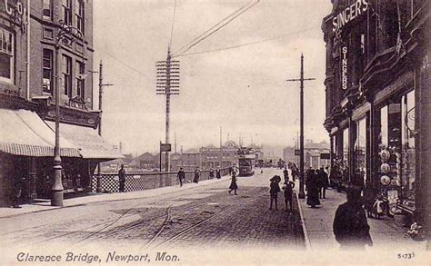 an old black and white photo of people walking down the street