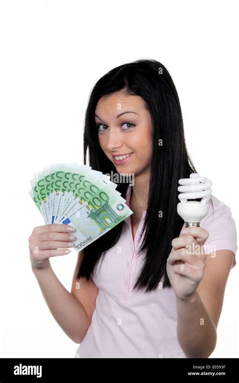 Woman with energy savings lamp energy lamp euro of money hi-res stock ...